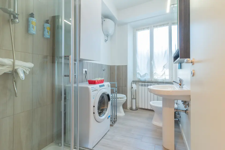 Bathroom with shower and washing machine